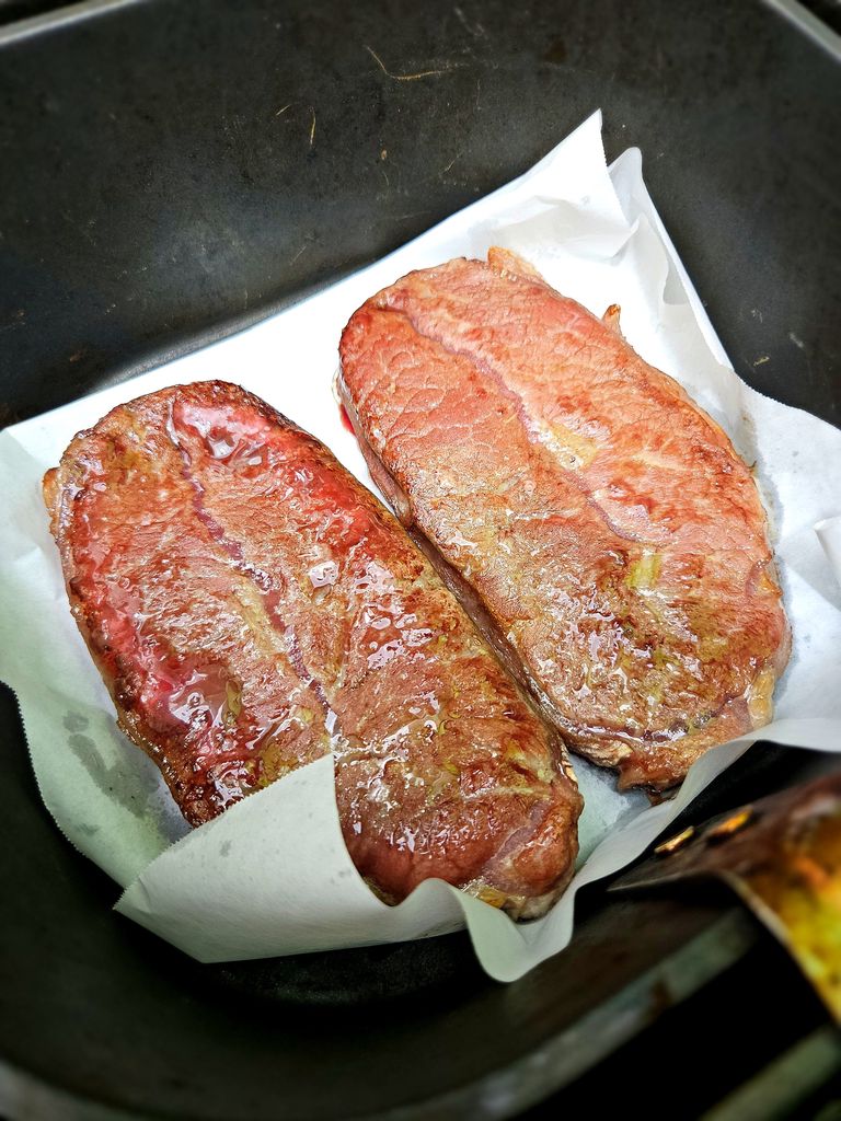Flipping the flat iron steak halfway through cooking Flipping the steak