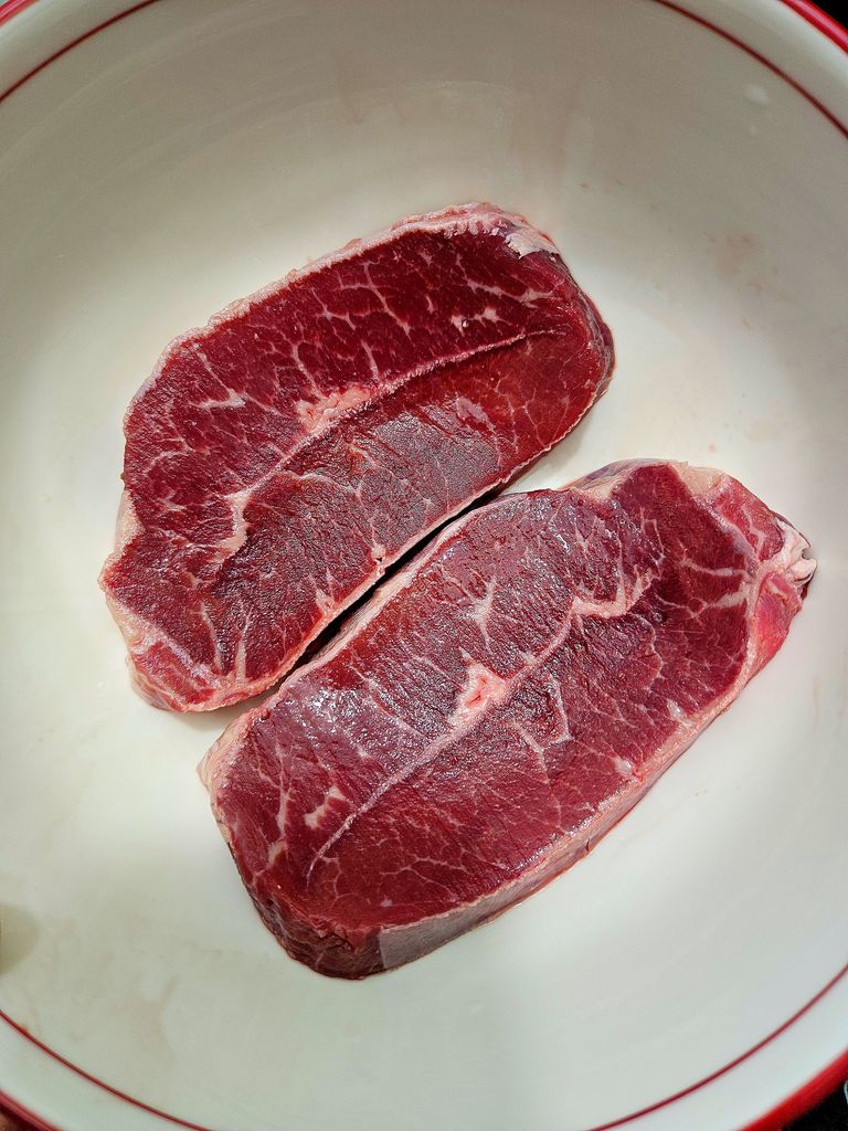 Beautifully marbled raw flat iron steak ready for seasoning Raw Flat Iron Steak