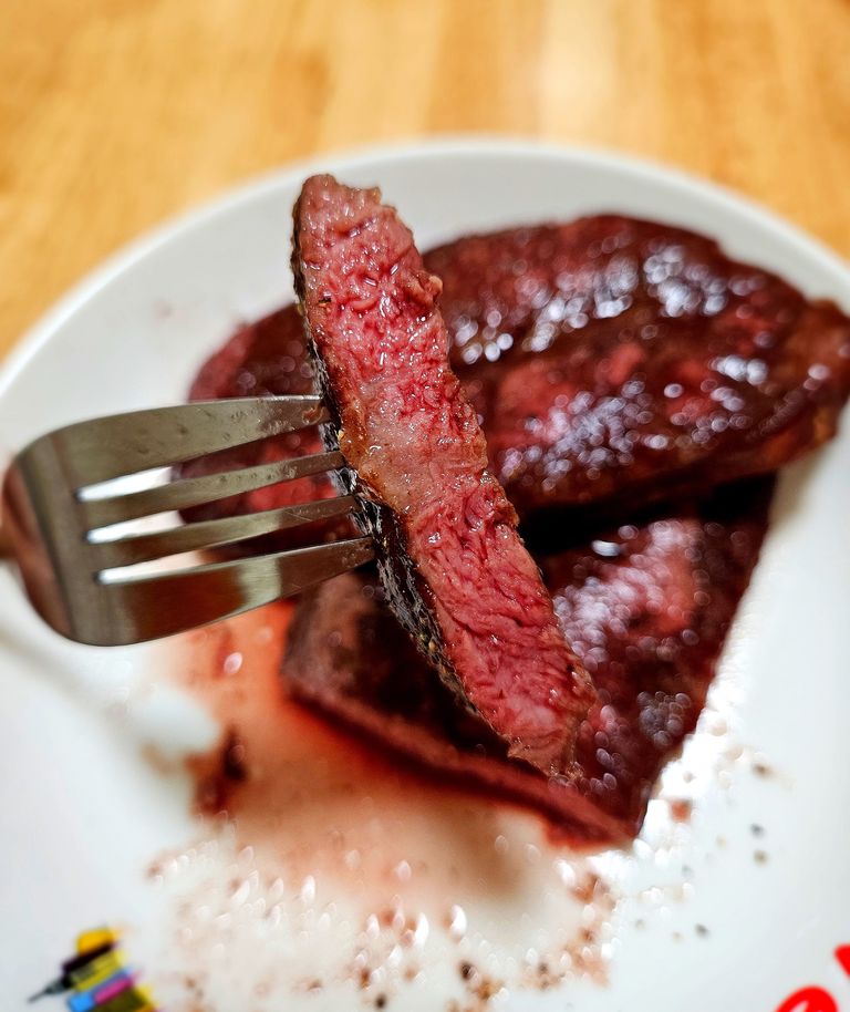 Slicing the rested flat iron steak against the grain for maximum tenderness Slicing flat iron steak