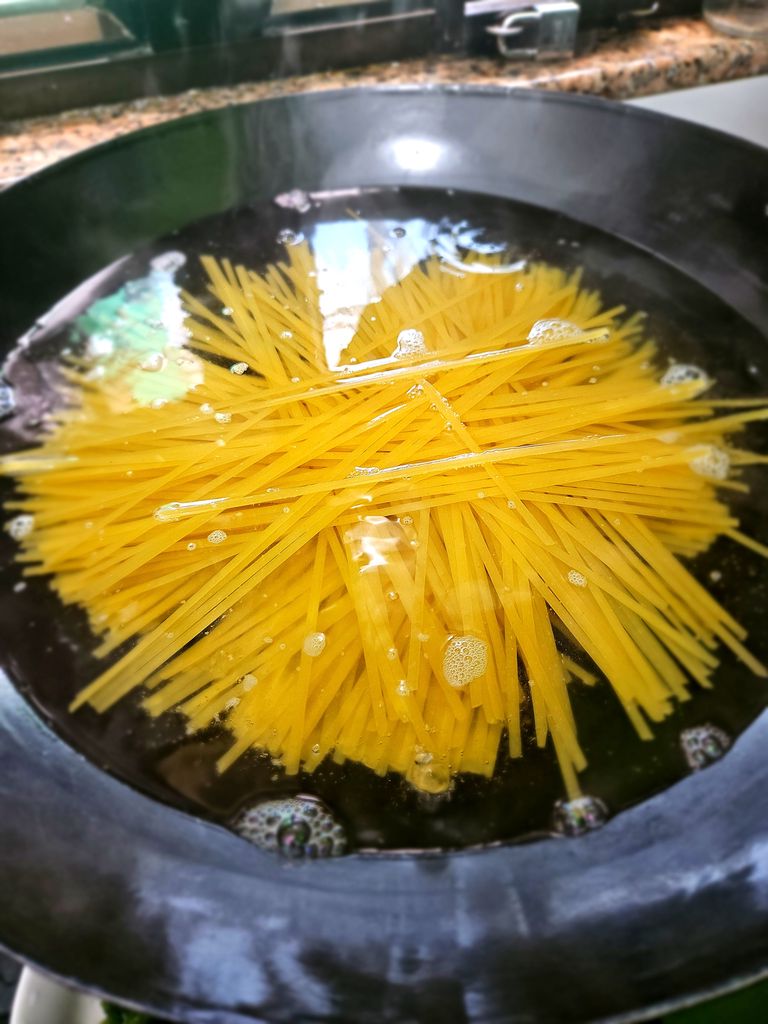 Boiling the pasta. As an Asian cook, my big wok is perfect for this — plenty of space to toss long pasta without snapping them in half. Highly recommended if you have one! Boiling pasta