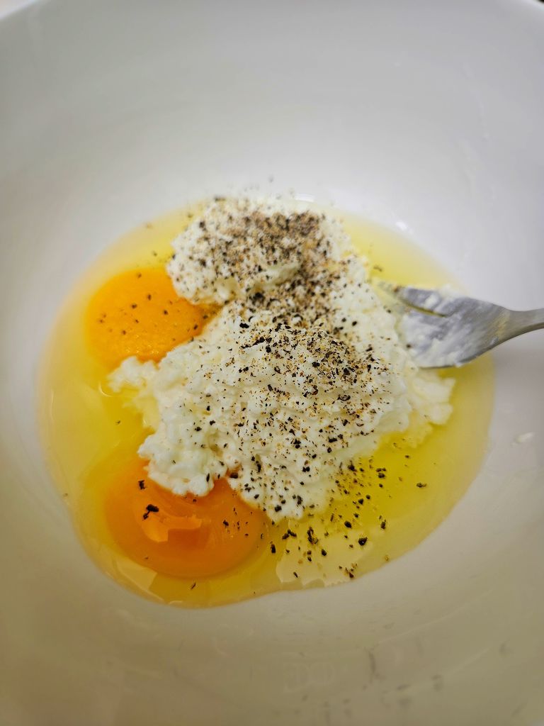 Mixing cottage cheese with egg Mixing sauce