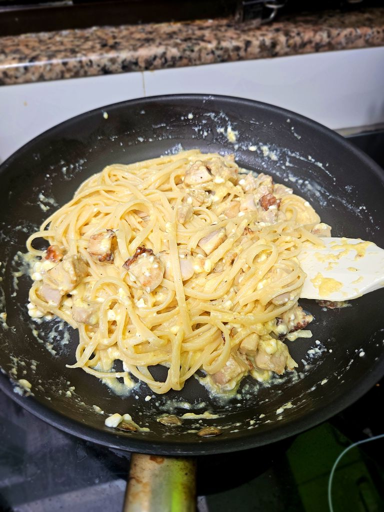 Finishing the carbonara gently so the egg stays silky Final toss