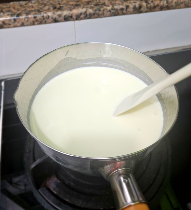 Heating milk and cream gently for the hojicha ice cream base Cook milk and cream