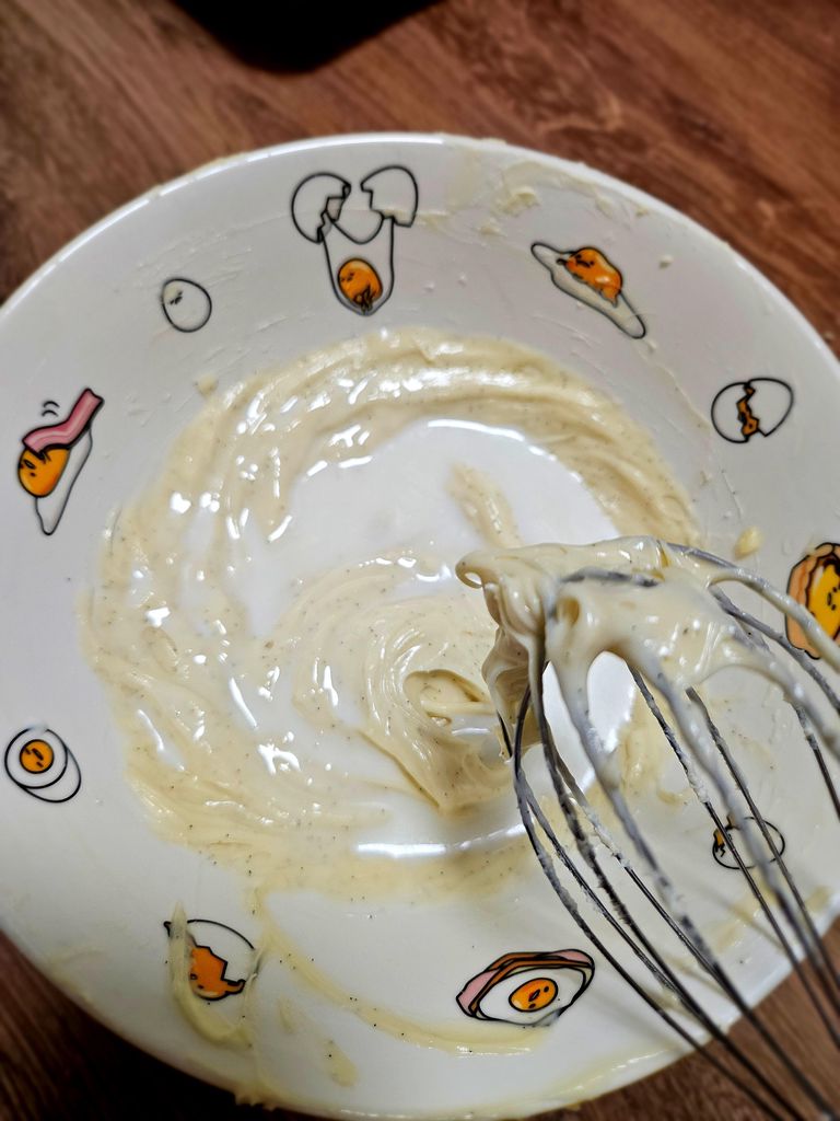 Adding milk one tablespoon at a time to reach desired glaze consistency. Adding milk to adjust consistency