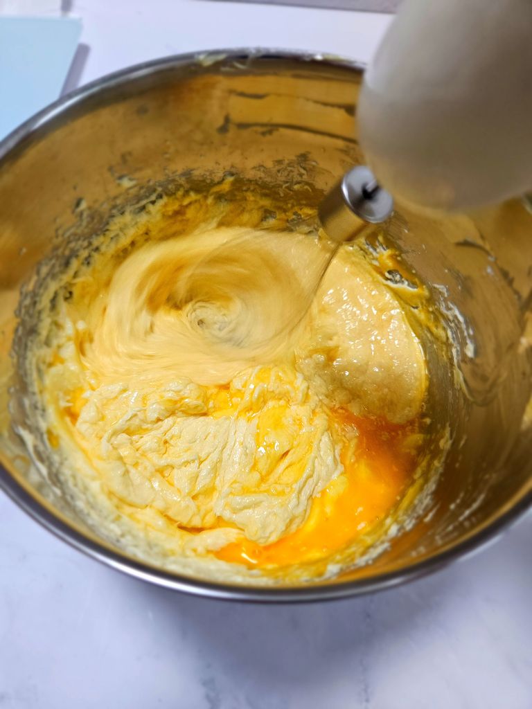 Adding and mixing the eggs Adding and mixing the eggs