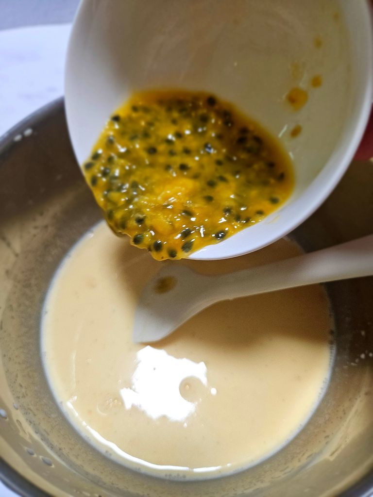 Stirring in passion fruit pulp Adding passion fruit