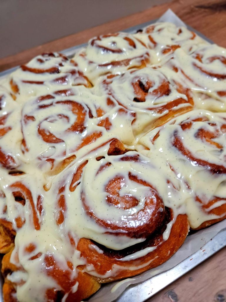 Warm cinnamon rolls drizzled with glaze — soft, tall, and full of spiral goodness. Freshly baked cinnamon rolls with glaze