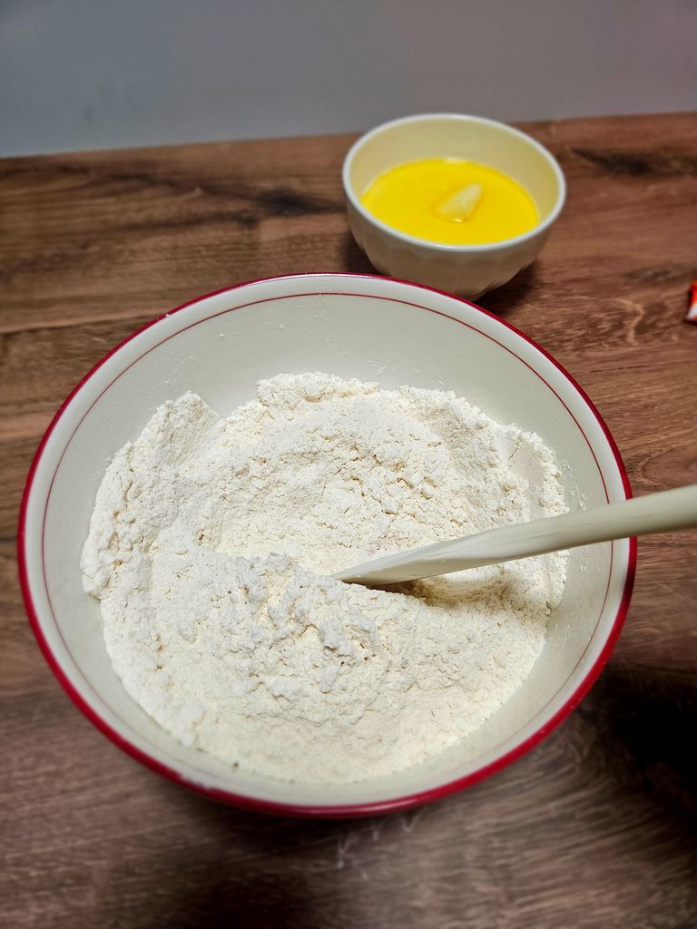 Flour blend, sugar, salt, and yeast combined. Dry ingredients combined