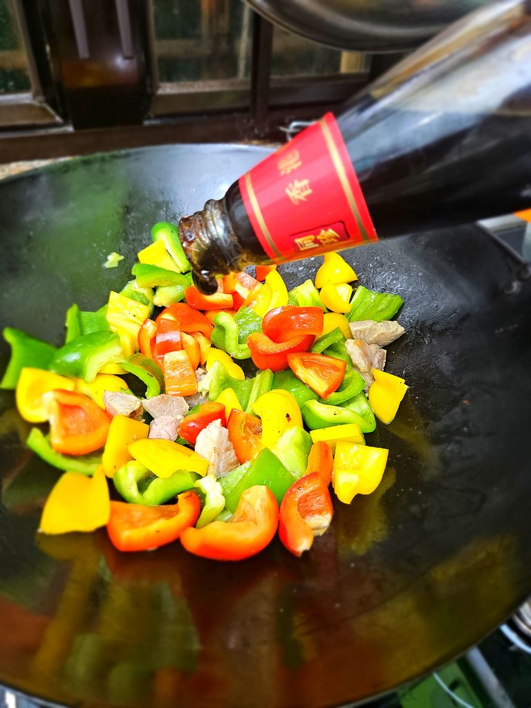 Adding the oyster sauce to the wok